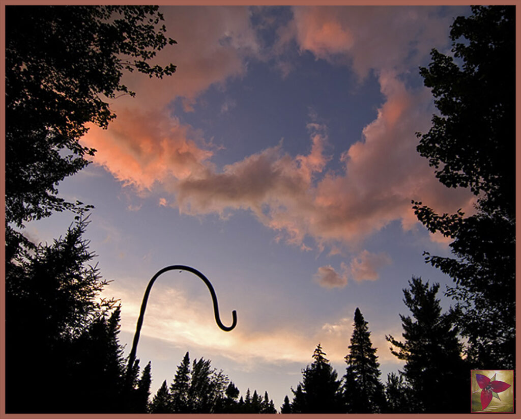 An empty sheppard's hook under a welcoming sky.